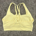 Top esportivo feminino de cor sólida com costas cruzadas macias, ideal para fitness, ioga e outras atividades físicas. Reforço de alta resistência e à prova de choque. Possui bojo para os seios.