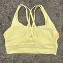 Top esportivo feminino de cor sólida com costas cruzadas macias, ideal para fitness, ioga e outras atividades físicas. Reforço de alta resistência e à prova de choque. Possui bojo para os seios.