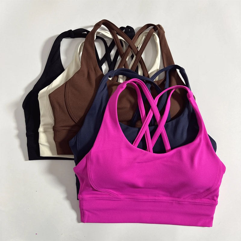 Top esportivo feminino de cor sólida com costas cruzadas macias, ideal para fitness, ioga e outras atividades físicas. Reforço de alta resistência e à prova de choque. Possui bojo para os seios.